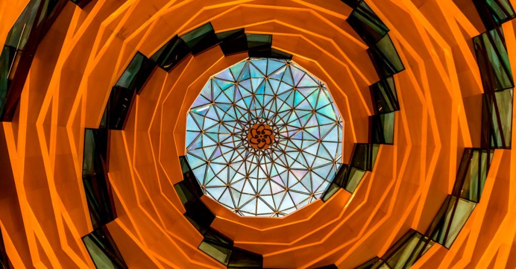 A stunning view of a spiral architectural ceiling featuring intricate geometric patterns and vibrant colors.